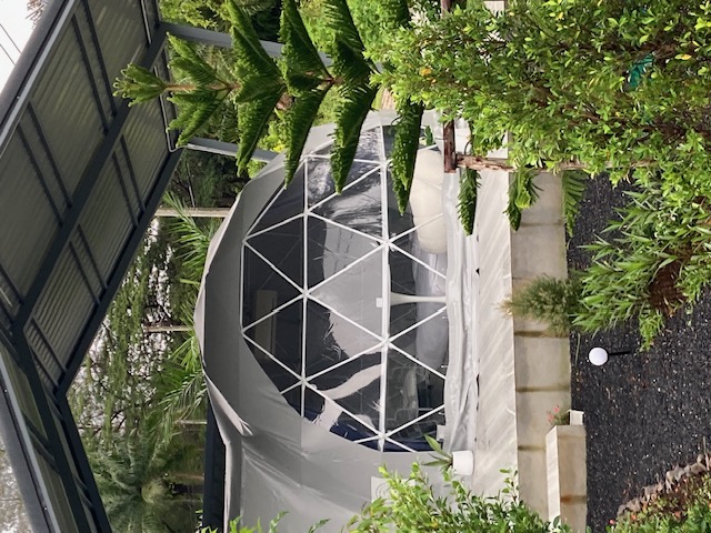 Close view of a dome tent with a geometric window and private deck