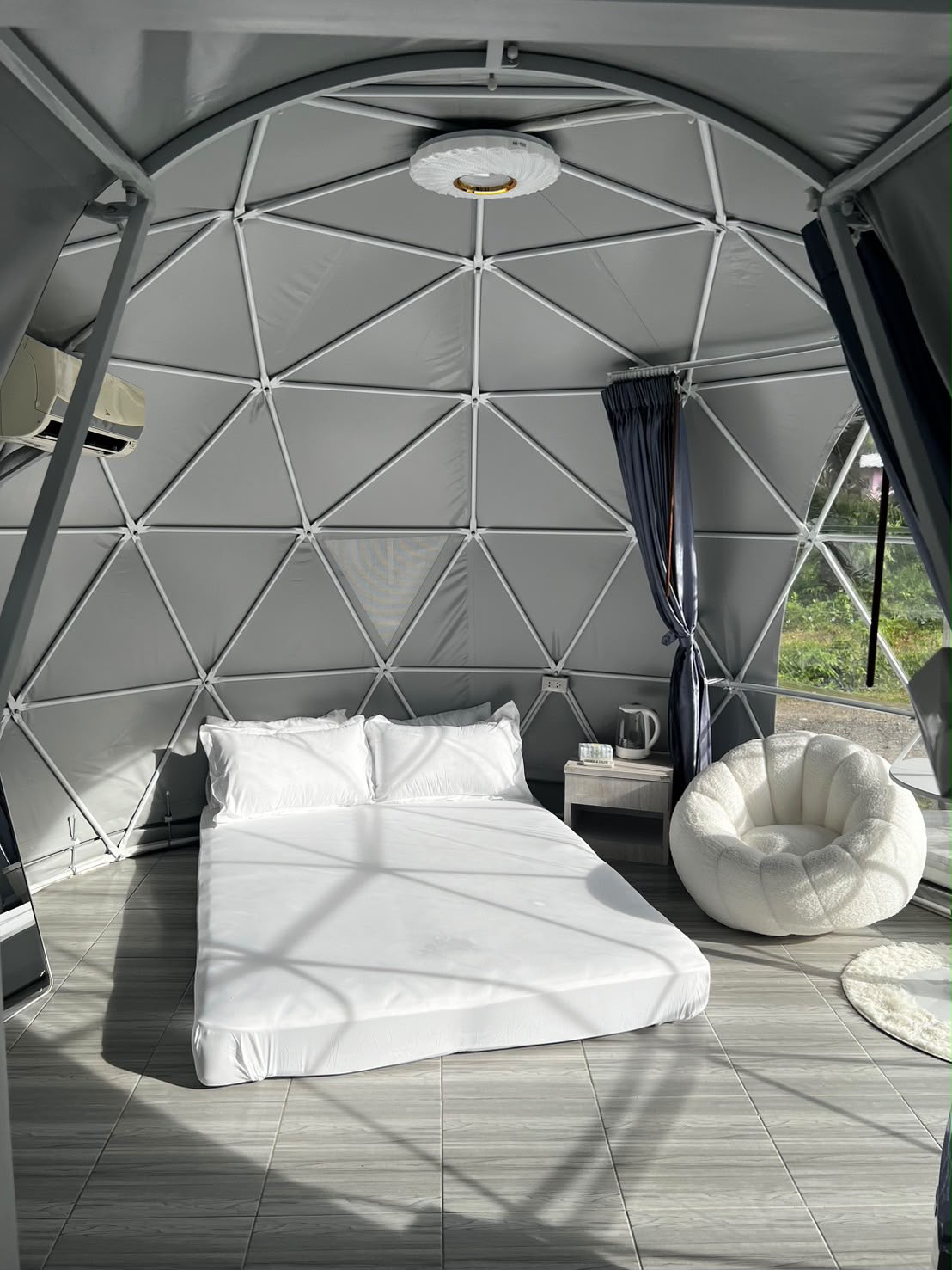 Wide view of the bed and geometric structure inside a dome at Wanasa